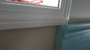 Fitting flush underneath the window trim.